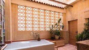 A spa area with a large bathtub, wooden paneling, and potted plants. - Beautiful apartment in front of the beach (El campello)