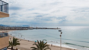 A beach with a view of the sea, a pier, and a building with a balcony. - Beautiful apartment in front of the beach (El campello)