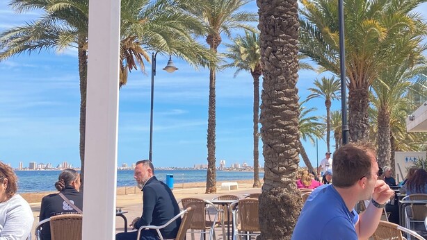 An outdoor seating area with palm trees and a view of the sea. - 2 Bed Det.Villa in La Manga Club.  5g Wi-Fi, Pool, A/C  winter monthly discounts (Los Belones)