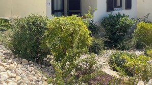 A two-story building with a white facade, multiple windows with shutters, and a balcony. - 2 Bed Det.Villa in La Manga Club.  5g Wi-Fi, Pool, A/C  winter monthly discounts (Los Belones)