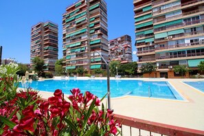 A swimming pool with a view of high-rise buildings in the background.