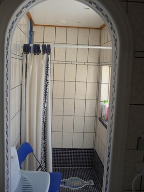 Shower, hair dryer, towels, toilet paper