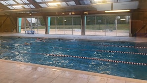 An indoor swimming pool with clear lane dividers, a bench, and a glass-enclosed roof. - Charming, centrally located house close to Carcassonne, perfect for families! (Capendu)