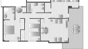 Un plan d’étage d’une chambre d’hôtel comprenant une cuisine, un coin repas et un petit balcon.