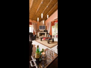 Relax by the fireplace in this inviting living room with a comfortable sofa, flat-screen TV, and coffee table.