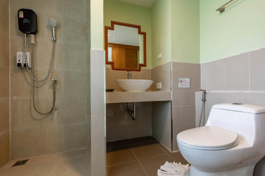 A bathroom with a shower, sink, and toilet.