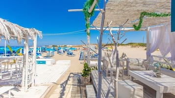 On the beach, sun-loungers