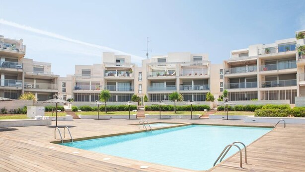 A modern hotel with a swimming pool, outdoor seating, and a landscaped garden. - Tierra de Mar 60 by homeprive (Denia)