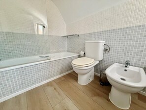 Bathtub, hair dryer, bidet, towels
