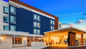 A modern hotel with a large sign reading "SPRINGHILL SUITES MARRIOTT".
