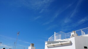 A white building with a white balcony railing and a clear blue sky. - TOWER. Walking distance to La Caleta. Ascensor.WIFI  (cadiz)