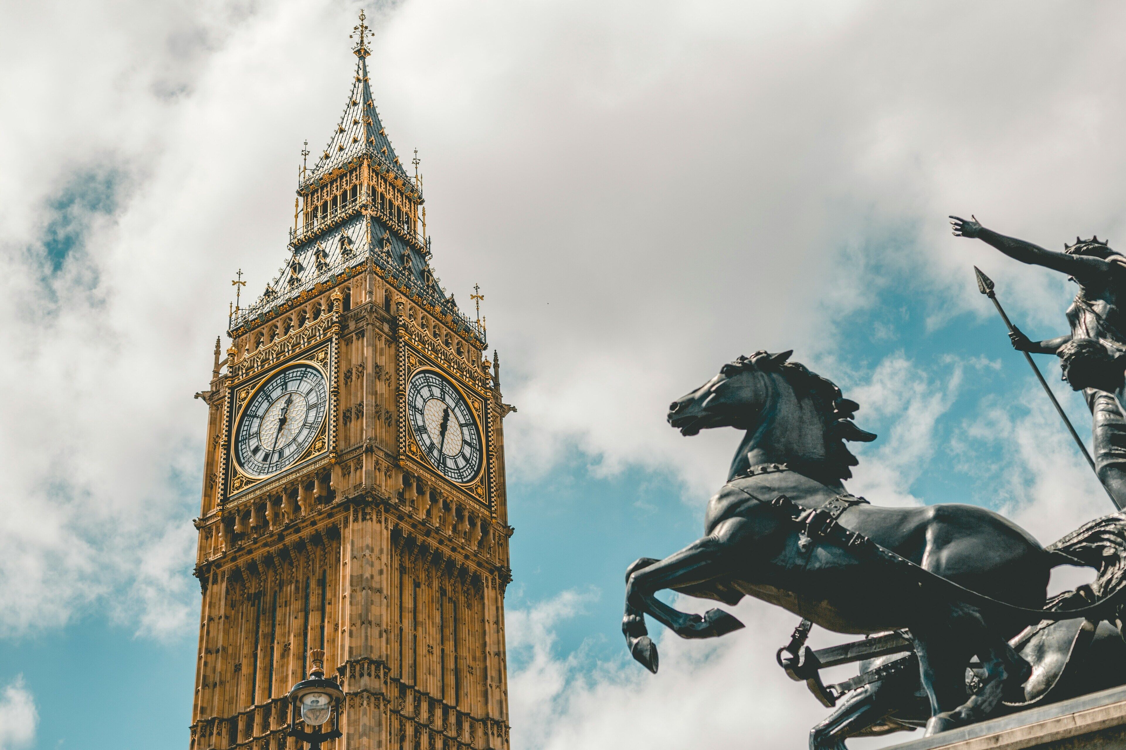 A clock tower with a statue of a horse and rider.