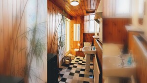 A wooden interior with a checkered floor, a sink, and a toilet.