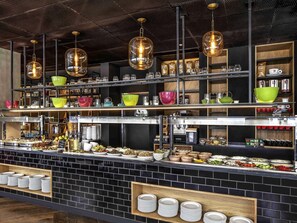 A buffet area with multiple serving stations, glassware, and a variety of food items. - ibis Styles Jerusalem City Center - An AccorHotels Brand (Jerusalem)