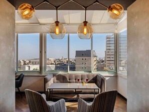 A modern room with a large window, a table, two chairs, and a hanging light fixture. - ibis Styles Jerusalem City Center - An AccorHotels Brand (Jerusalem)