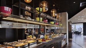 A buffet area with various food options and a modern interior design. - ibis Styles Jerusalem City Center - An AccorHotels Brand (Jerusalem)