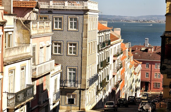 A row of buildings with balconies overlooking a body of water.