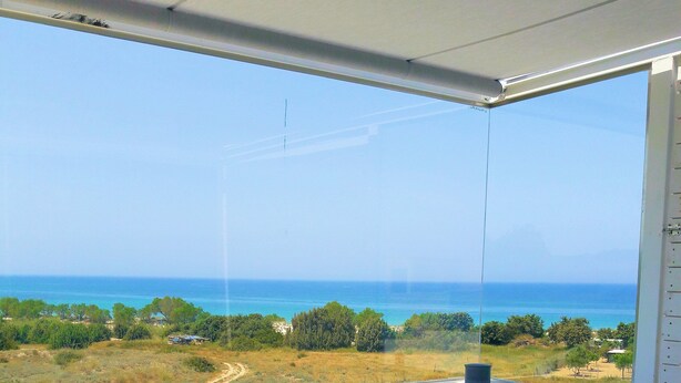 A hot tub with a view of the ocean, a blue towel, and a flower on the edge. - Seabreeze, a new luxury seafront villa for up to 9 people (Mastichari)