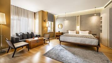 Un dormitorio moderno con una cama grande, un sofá, una mesa de centro y un escritorio.
