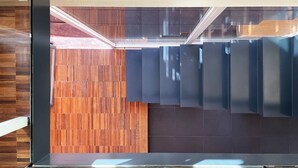 A modern interior with a wooden panel wall and dark-toned cabinets. - URG - Luxury penthouse in Catania Unesco centre (catania)