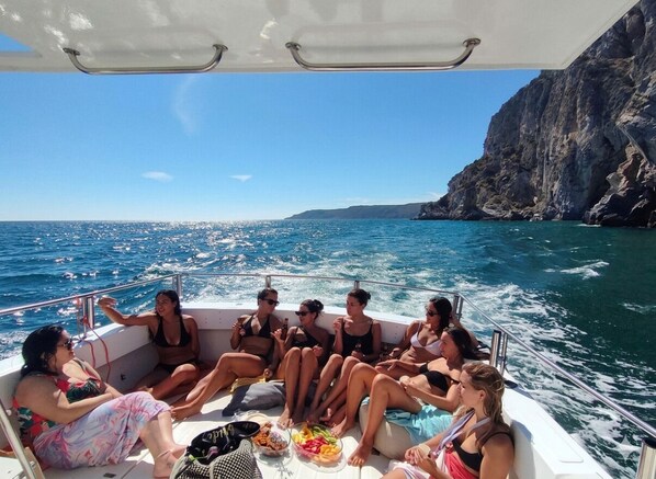 A group of people on a boat with a rocky coastline in the background. - 2 POOLS, FOOTBALL PITCH, TENNIS COURT, CINEMA ROOM, GYM, BAR, PRIVATE CHEF (Poceirão)
