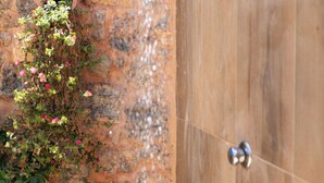 A shower with a stone wall and a wooden door. - Private Pool★Stone Villa★ BBQ & Wifi★ Jacuzzi (Astratigos)