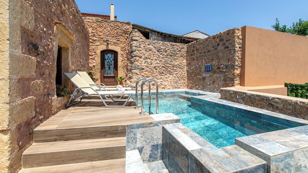 A stone-walled pool area with steps leading to a door, surrounded by a wooden deck. - Private Pool★Stone Villa★ BBQ & Wifi★ Jacuzzi (Astratigos)