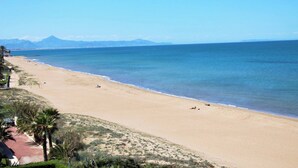 A beach with a clear view of the ocean and distant mountains. - Sunrise 01 by homeprive (Denia)