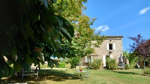 A stone building with a garden in front.