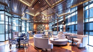 A spacious lobby with modern furniture, large windows, and a prominent clock. - Mövenpick Hotel & Convention Centre KLIA (Sepang)