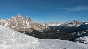 Un paysage montagneux enneigé, avec des pics escarpés et un ciel dégagé.