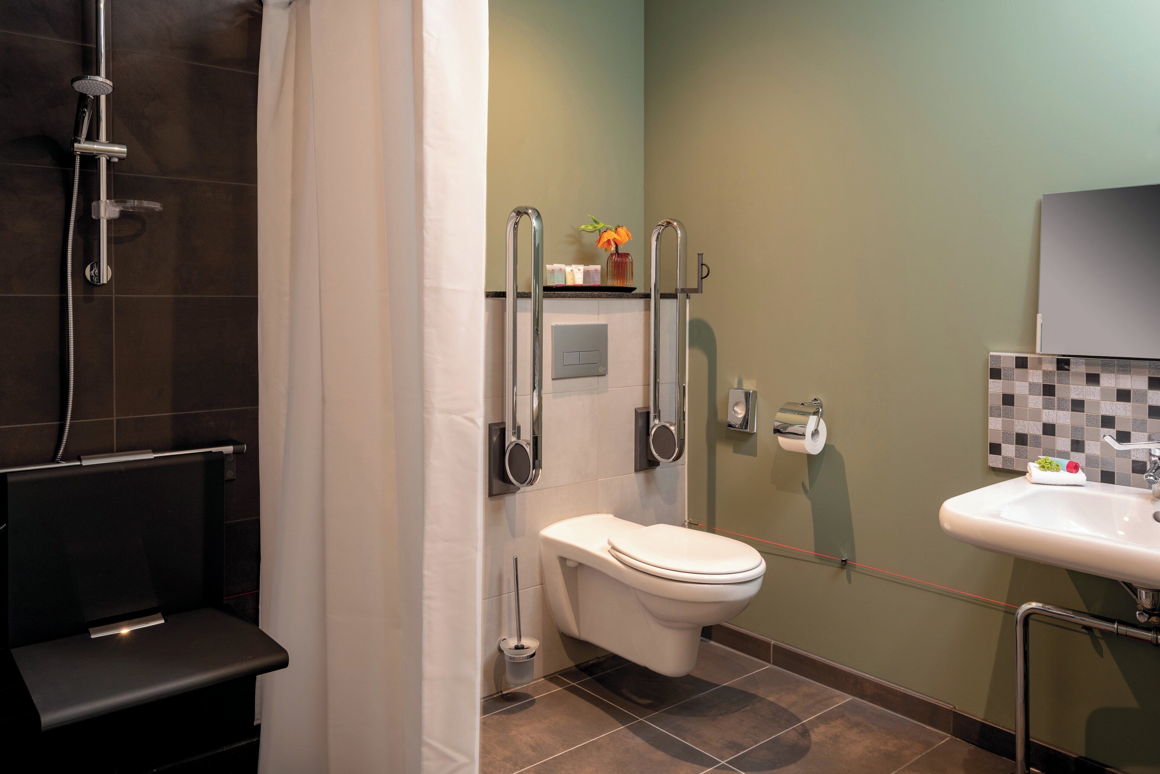 A bathroom with a shower, toilet, and sink.