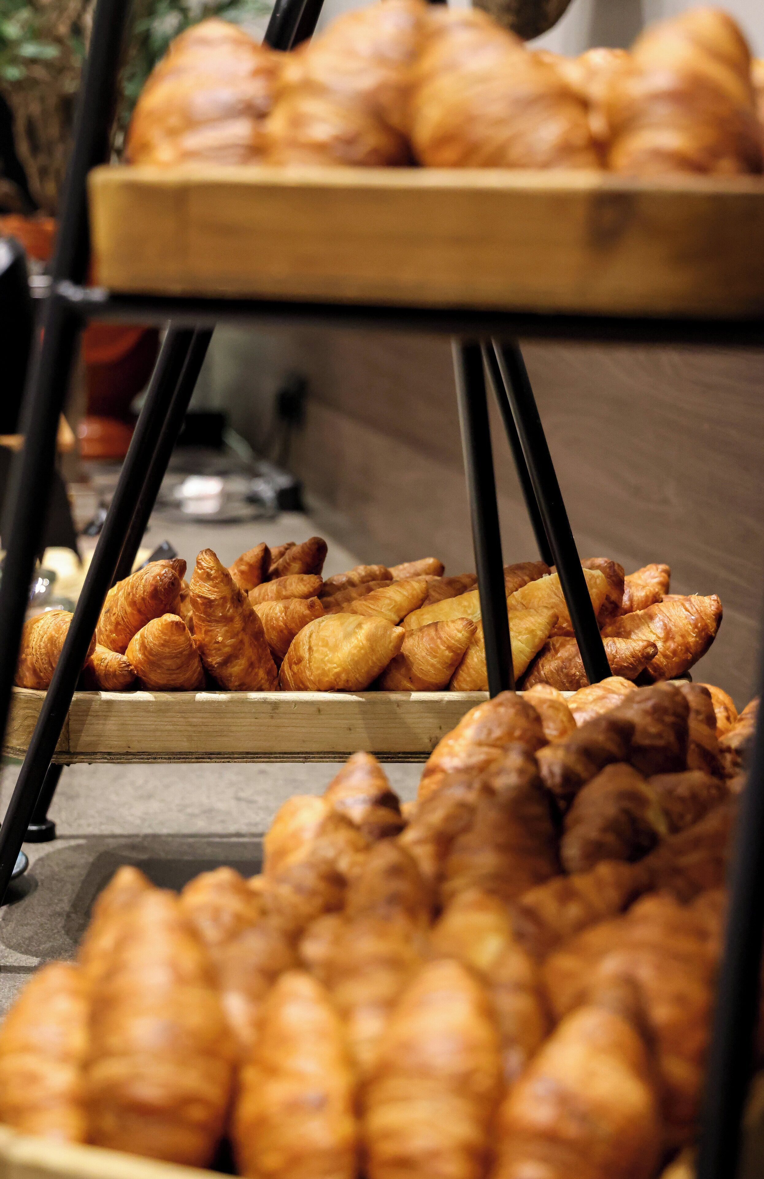 A display of assorted pastries on a wooden stand.