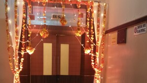 A decorated entrance with a sign reading "MINI HALL". - Alhind Calicut Tower (Kozhikode)