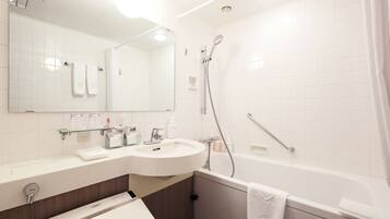 A modern bathroom with a white sink, mirror, and bathtub.