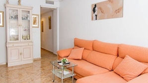 A living room with a sofa, a glass coffee table, and a cabinet. - cozy apartment with 140m terrace with private pool (Torrevieja)