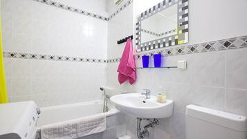 Bathtub, hair dryer, towels