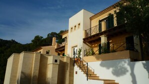 A modern building with a staircase leading to a balcony. - Dream location in Costa Canyamel (Canyamel)