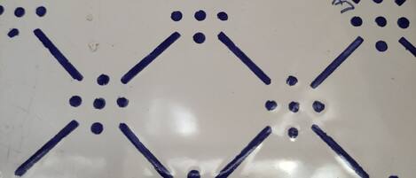 A tiled floor with a geometric pattern of lines and dots.