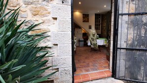 A doorway leading to a room with a tiled floor, a table with a tablecloth, and a plant. - PROVENCE stone house with private pool (Lorgues)