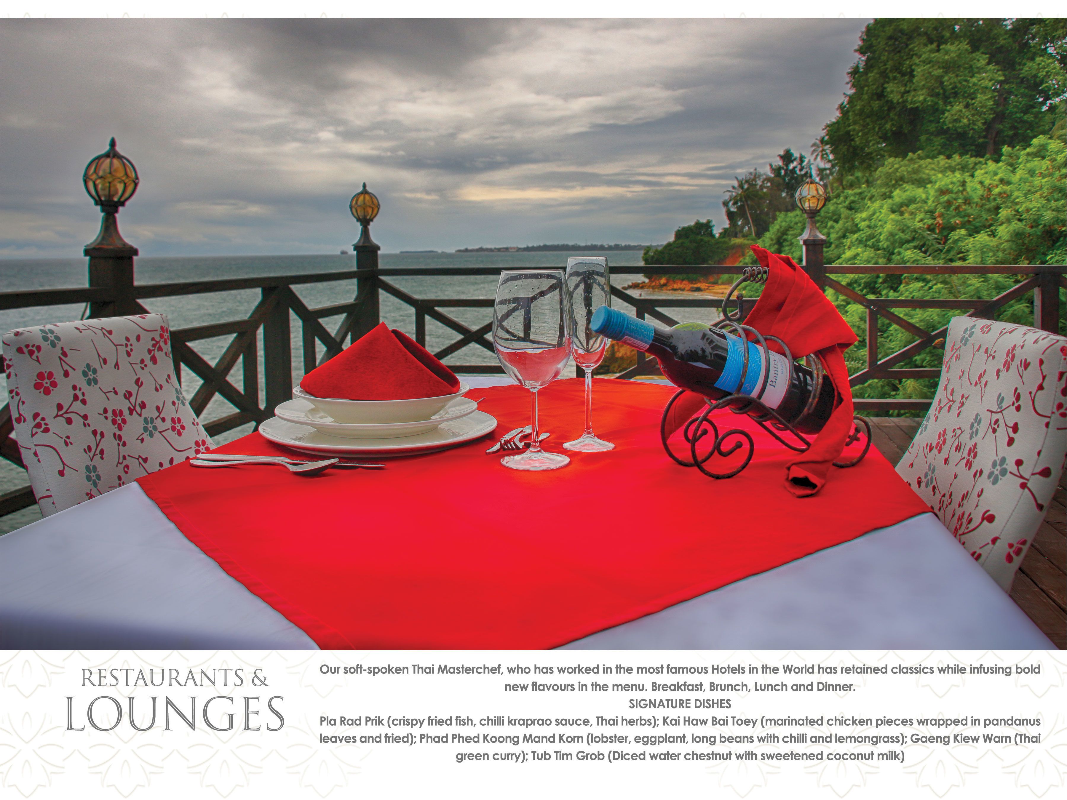 A table set for dining with a red tablecloth, two wine glasses, and a bottle of wine.