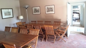 Enjoy meals in this cozy dining area with a long table and comfortable chairs.