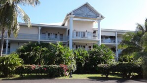A large, two-story building with a central balcony and multiple balconies on each floor. - Nice duplex in Saint François in Guadeloupe (Saint François)