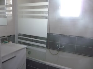 Banheira, secador de cabelo, toalhas de banho