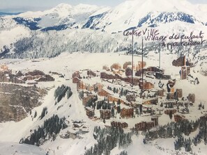 A snow-covered mountain town with multiple buildings and a ski lift. - Avoriaz heart station F2 redone nine feet tracks 45 m2 (Morzine)
