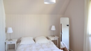 A bedroom with a bed, two bedside tables, a mirror, and a hanging light fixture. - House Heart LOCTUDY - Close Sea and Beach on foot. (Loctudy)