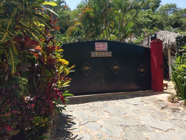 A gated entrance with a sign indicating a dog-friendly area.