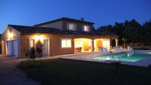 A two-story house with a swimming pool, outdoor seating, and a well-lit patio area. - Recent Provencal villa, 8 rooms, all comfort with swimming pool on closed space (Cotignac, Monfort sur Argens)