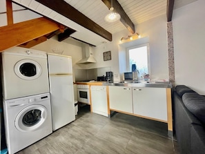 A compact kitchen with a washing machine, oven, and dishwasher. - Reder Mor : maison de pêcheurs 250 m de la mer (SANTEC)