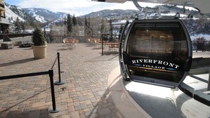 Un télésiège au Riverfront Village offrant une vue sur les montagnes enneigées.